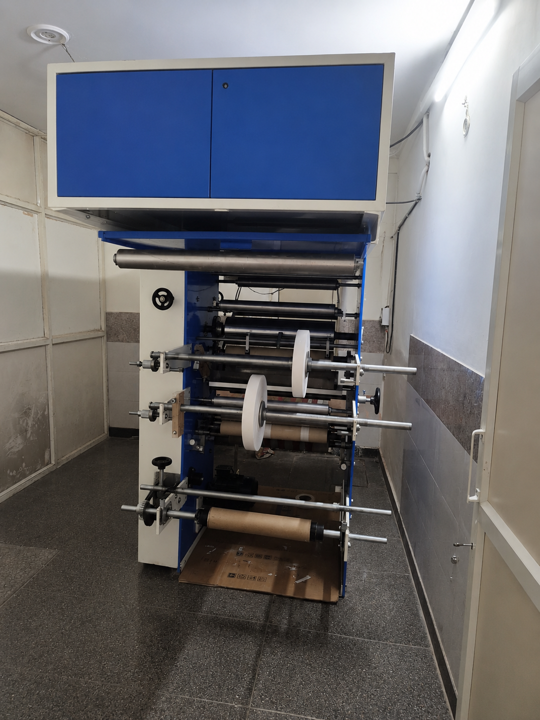 Side gumming label machine with paper rolls at Prompt Creations